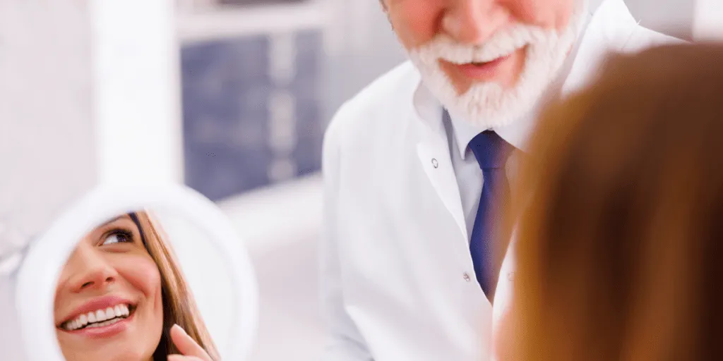 Dentist at a teeth whitening procedure